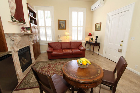 The Napa Inn - living room with fireplace and table with chairs