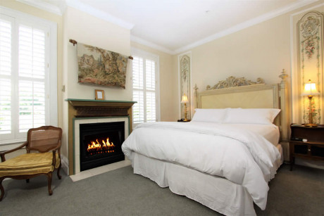room with bed, fireplace and chair